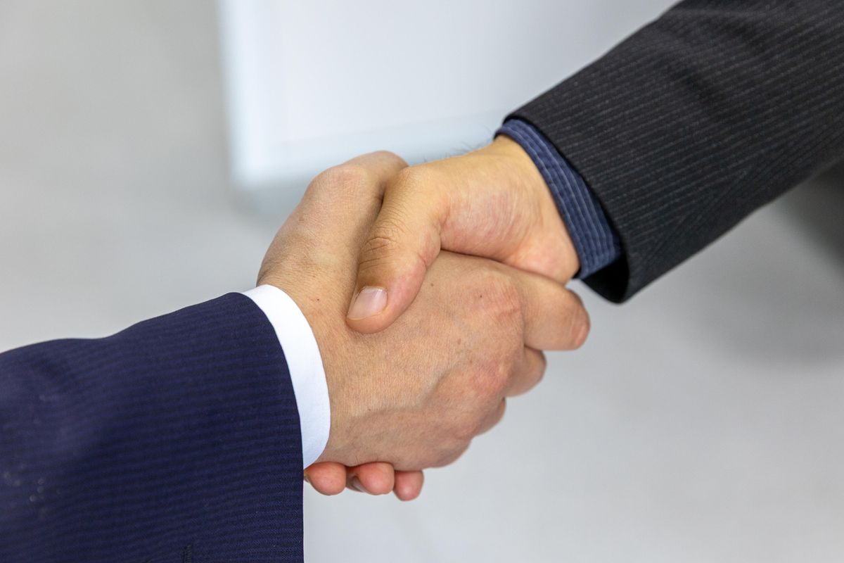 Plumber and homeowner shaking hands after a completed job